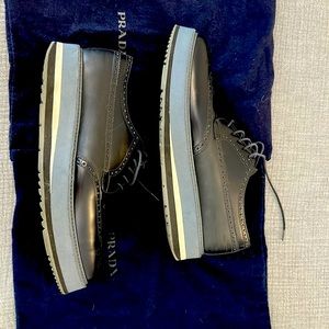 Prada platform brogues in black, grey/blue